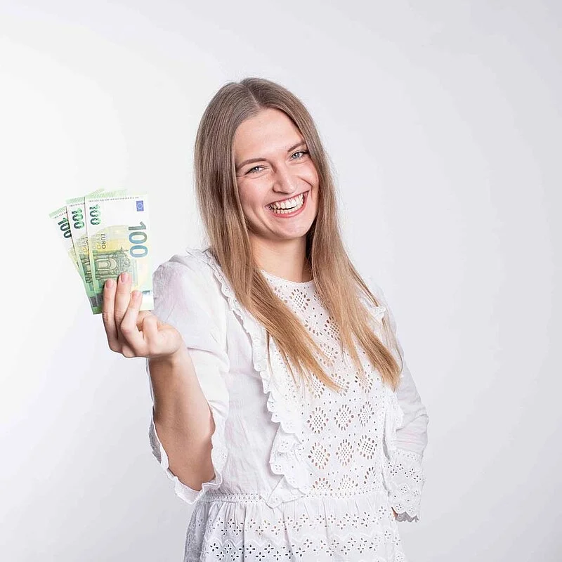 Auszahlung-OPTINVEST Frau hält Geldscheine in der Hand | OPTINVEST